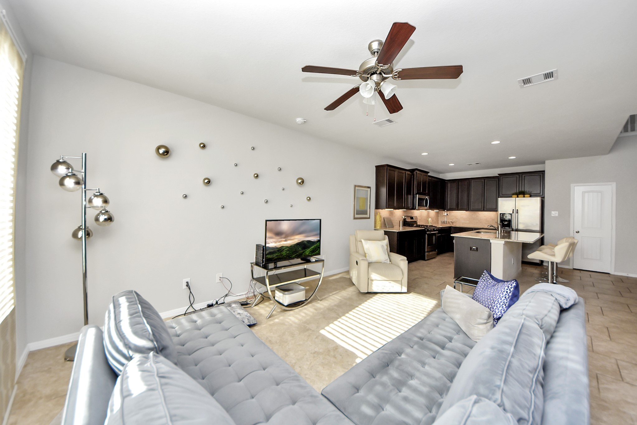 3310 Rainflower Springs Lane Rosenberg, TX 77471 - Photo 10 of 31 Another view of the open living area, with a stunning kitchen visible in the background, offering a perfect space for hosting.