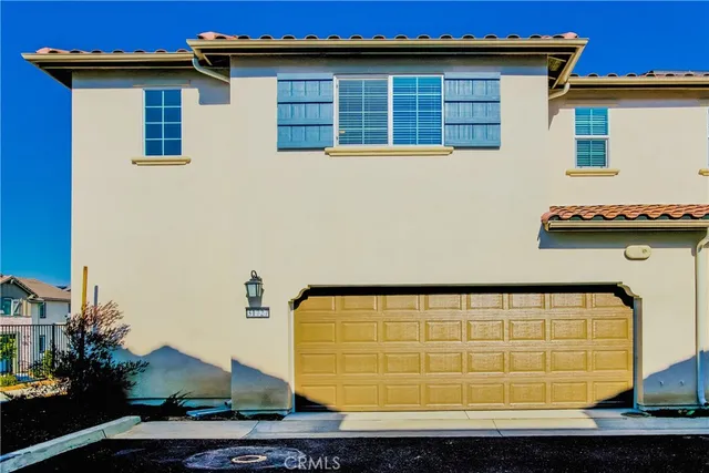 a view of a blue house with large windows
