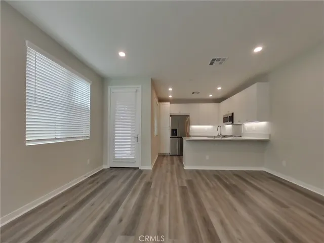a view of a kitchen with a sink and a large window