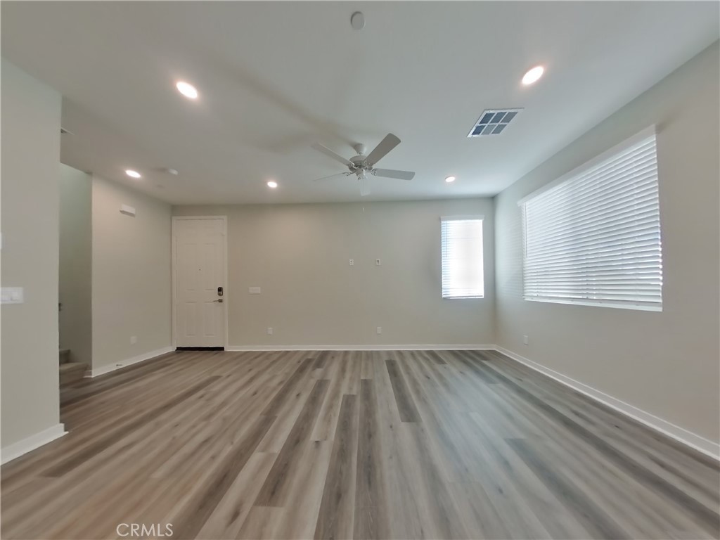 31727 Willowood Way Menifee, CA 92584 - Photo 3 of 31 an empty room with wooden floor and windows