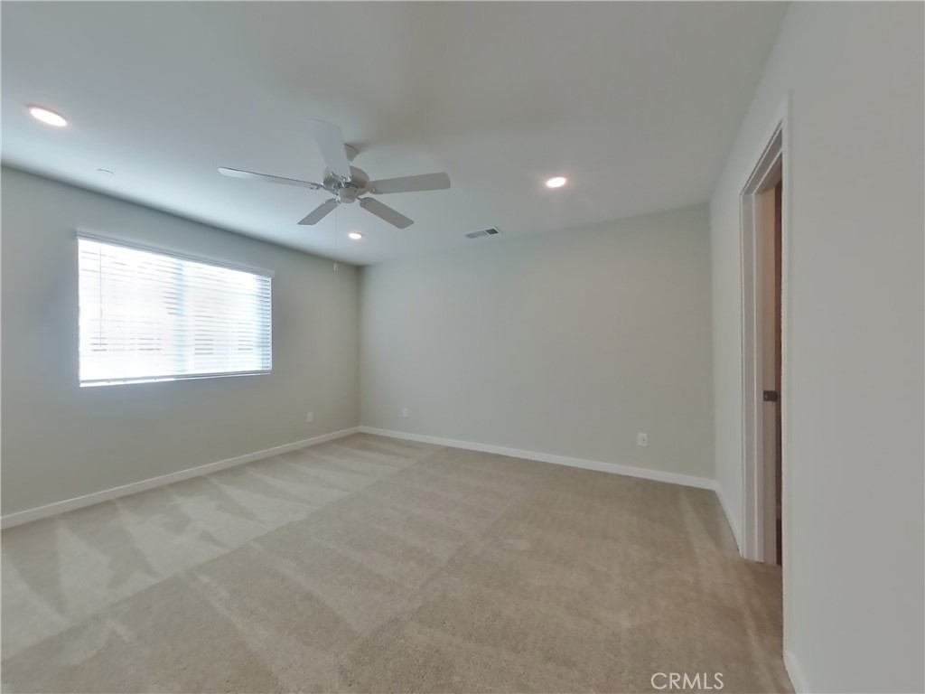 31727 Willowood Way Menifee, CA 92584 - Photo 6 of 31 an empty room with windows and fan