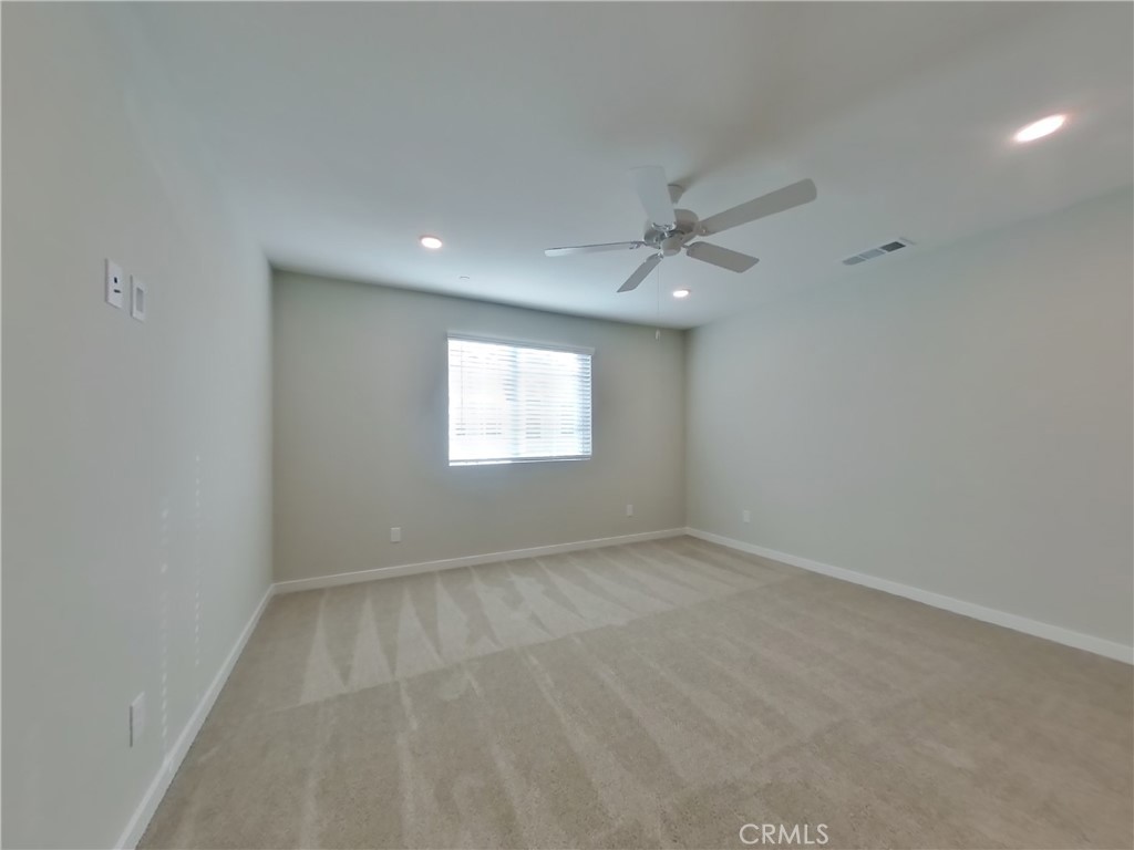 31727 Willowood Way Menifee, CA 92584 - Photo 7 of 31 an empty room with a window and a fan