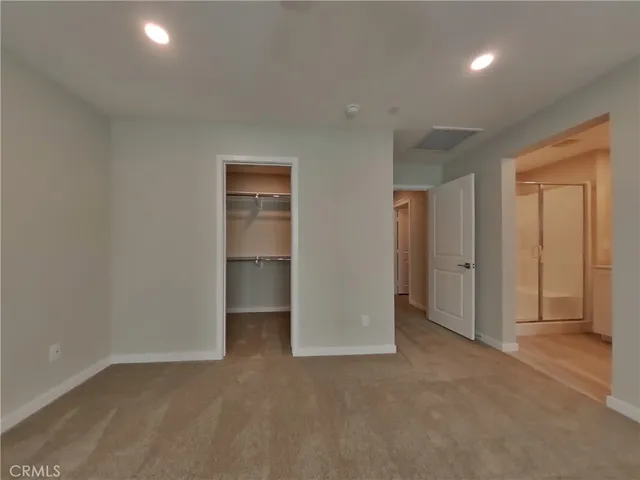 a view of an empty room and closet area