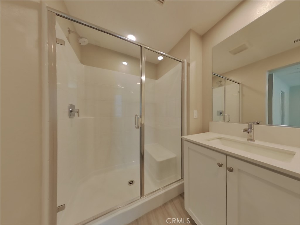 31727 Willowood Way Menifee, CA 92584 - Photo 10 of 31 a bathroom with a shower sink vanity and mirror