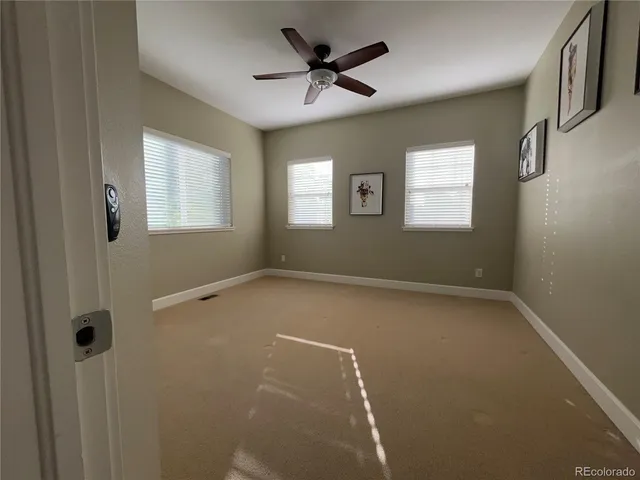 a view of a livingroom with a ceiling fan and window