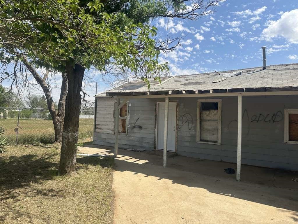 3406 East 15th Street Lubbock, TX 79403 - Photo 1 of 9 a front view of a house with a yard
