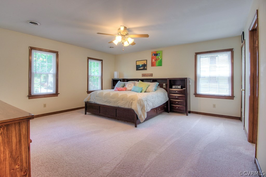 3108 Nahant Road Midlothian, VA 23112 - Photo 14 of 29 a spacious bedroom with a bed and a chandelier
