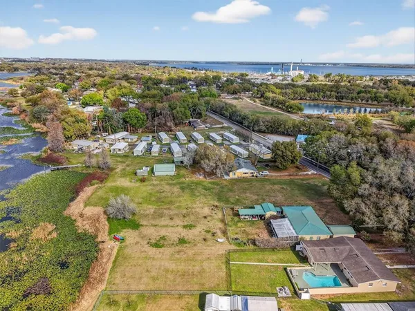 an aerial view of residential houses with outdoor space and swimming pool