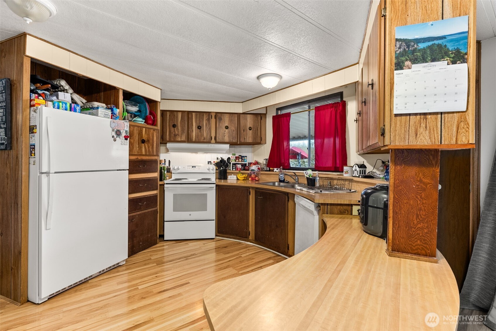 738 Gish Road Onalaska, WA 98570 - Photo 14 of 40 a kitchen with a refrigerator wooden floor and window