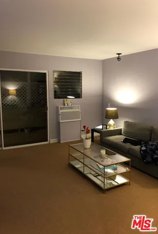 a living room with furniture pool and a flat screen tv