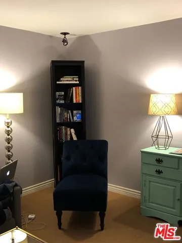 a living room with furniture and a lamp