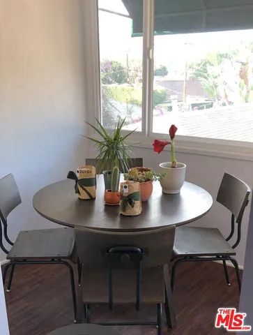 a view of a dining room with tables and chairs