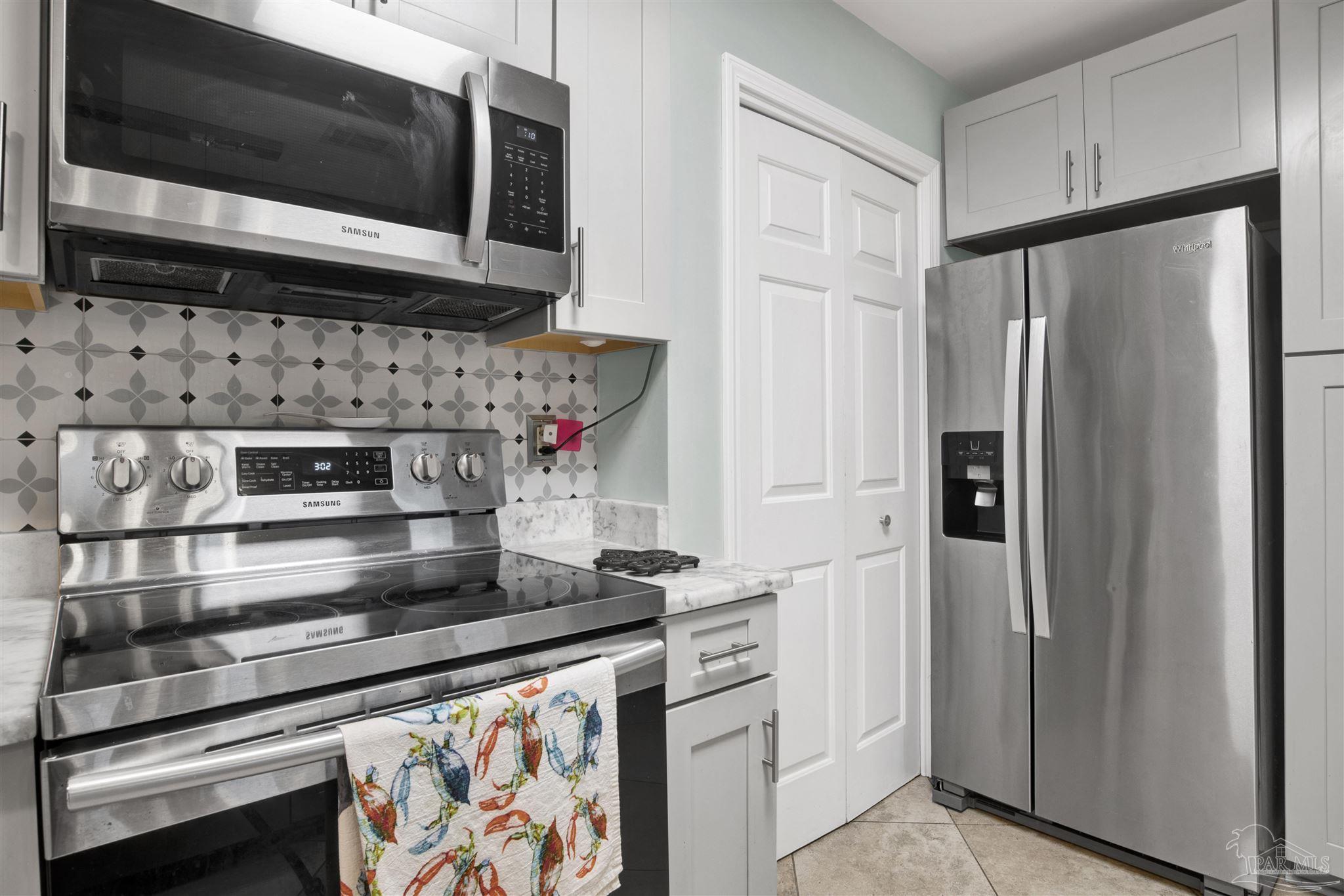 13351 Johnson Beach Road, Unit 203E Perdido Key, FL 32507 - Photo 14 of 55 a kitchen with stainless steel appliances a refrigerator and a microwave