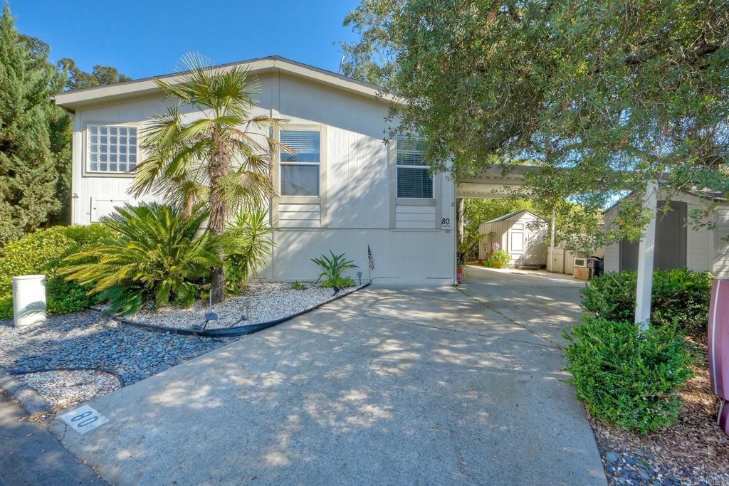 18218 Paradise Mountain Road Valley Center, CA 92082 - Photo 1 of 36 a front view of a house with garden