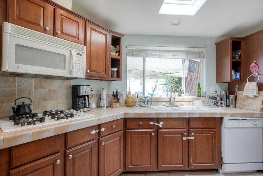 18218 Paradise Mountain Road Valley Center, CA 92082 - Photo 12 of 36 a kitchen with granite countertop stainless steel appliances a sink and cabinets