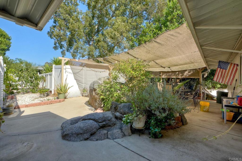18218 Paradise Mountain Road Valley Center, CA 92082 - Photo 30 of 36 a yellow house with outdoor sitting space