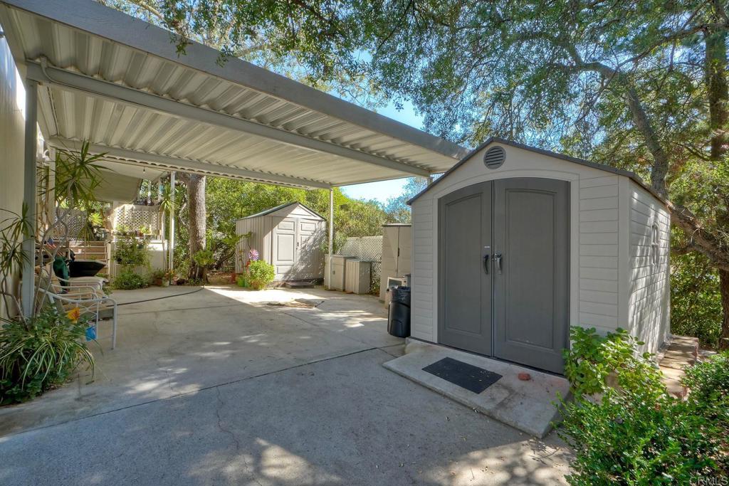 18218 Paradise Mountain Road Valley Center, CA 92082 - Photo 5 of 36 a yellow house with a outdoor space