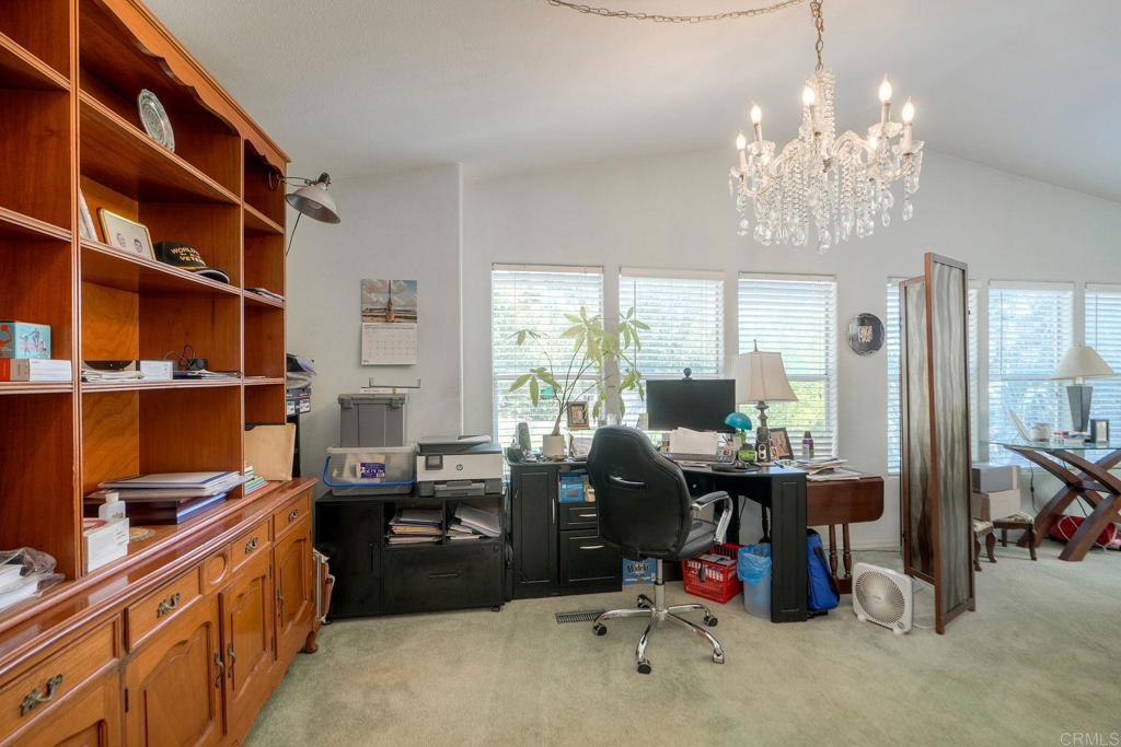 18218 Paradise Mountain Road Valley Center, CA 92082 - Photo 8 of 36 a view of a workspace with furniture and a window