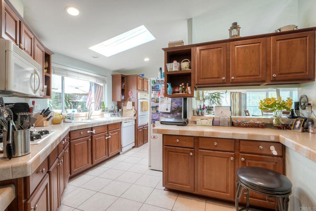 18218 Paradise Mountain Road Valley Center, CA 92082 - Photo 10 of 36 a kitchen with stainless steel appliances granite countertop a sink and cabinets