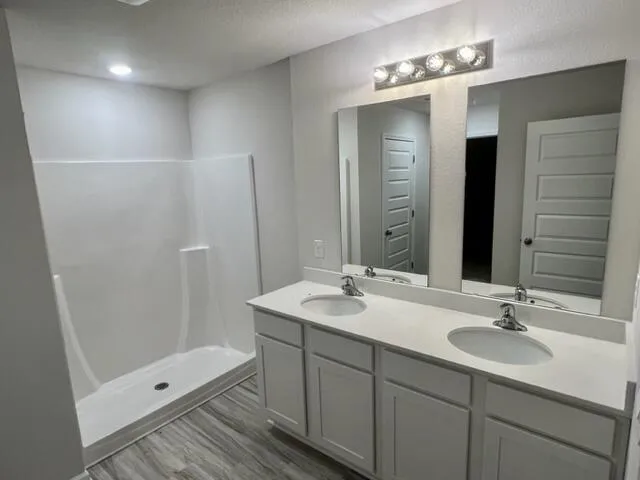 a bathroom with a double vanity sink and mirror