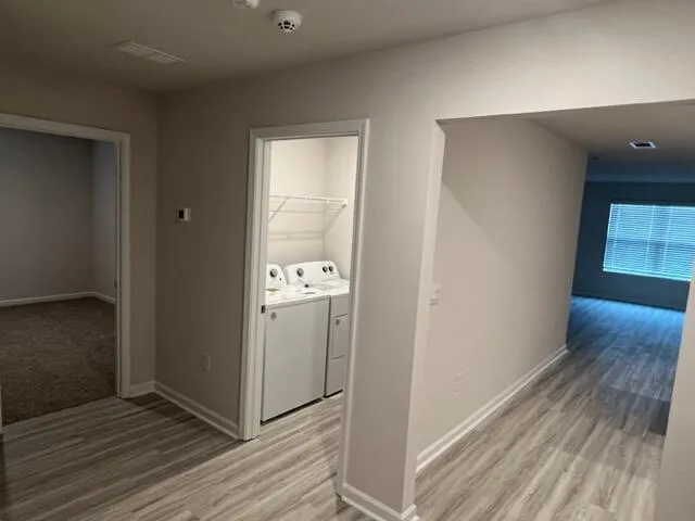 a view of hallway with wooden floor