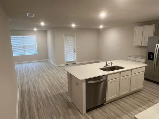 a kitchen with a sink and cabinets