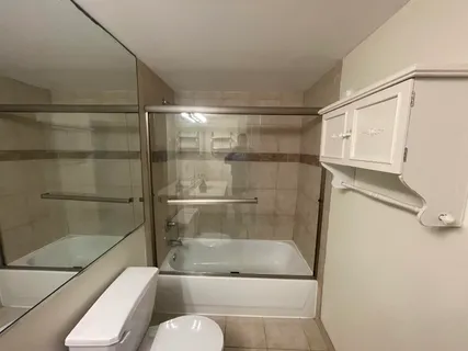 a bathroom with a shower a toilet and a sink
