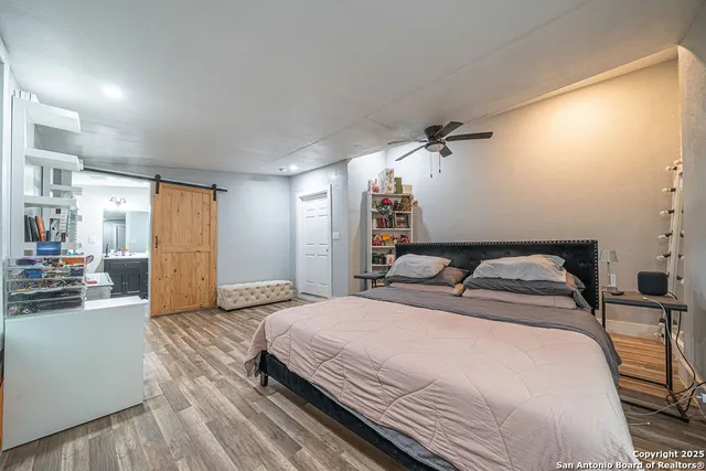 a spacious bedroom with a bed and a cabinets