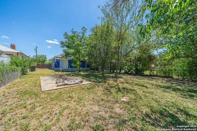 a view of a backyard with large trees