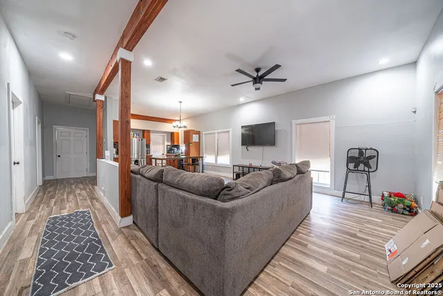 a living room with furniture and a wooden floor