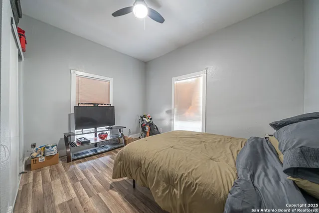 a bedroom with a bed and a flat tv screen on a dresser