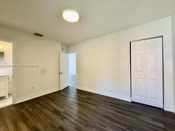 a view of an empty room and wooden floor