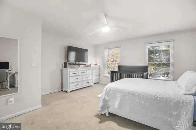 a bedroom with a bed and a television