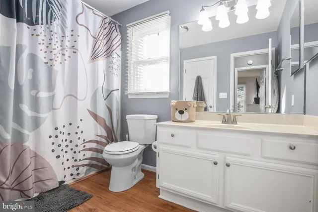 a bathroom with a sink toilet mirror and shower