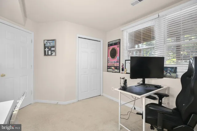 a work room with furniture and a flat screen tv