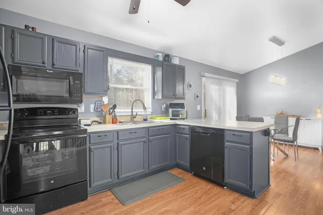 a kitchen with stainless steel appliances granite countertop a stove sink and cabinets