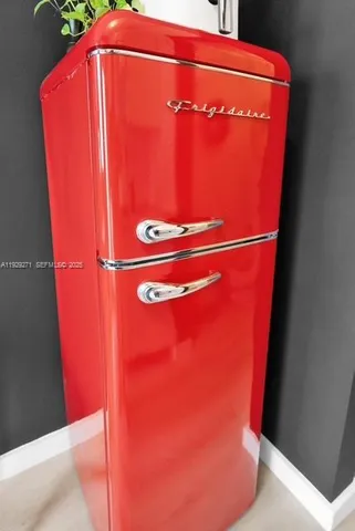 a dining room with furniture a window and a potted plant