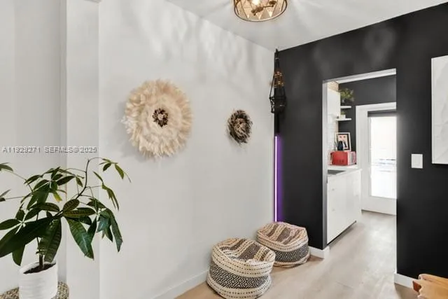 a living room with furniture and a floor to ceiling window