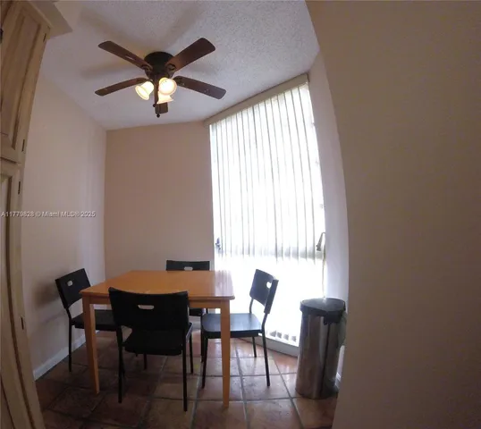 a view of a dining room with furniture and window