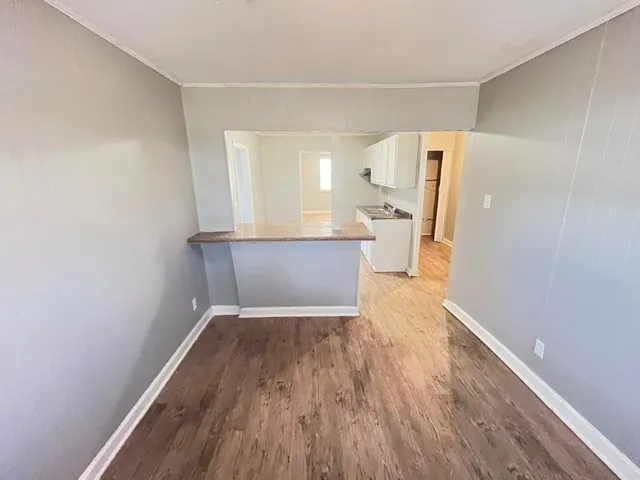 a view of a kitchen cabinets a sink and a wooden floor