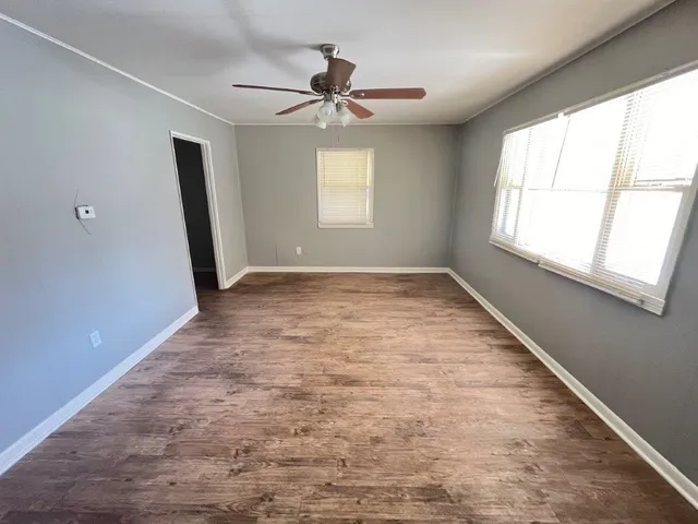 wooden floor in an empty room with a window