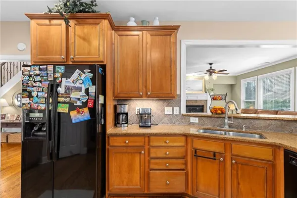 a kitchen with granite countertop wooden cabinets and a stove top oven