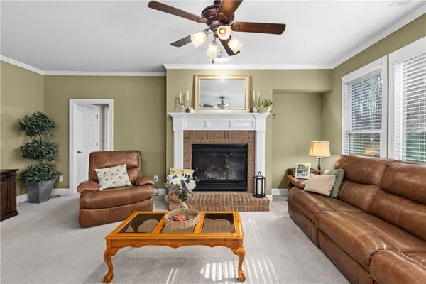 a living room with furniture a flat screen tv and a window