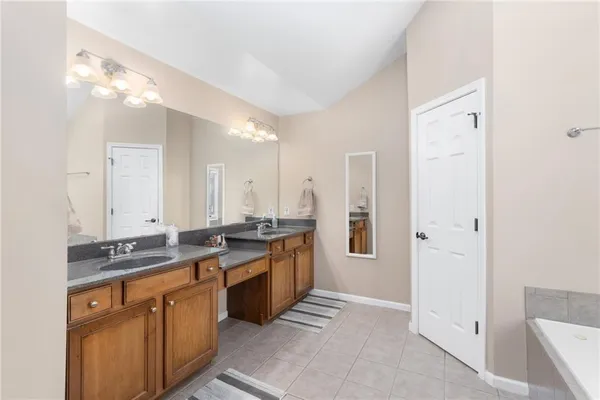 a en suite bathroom with a sink and a mirror