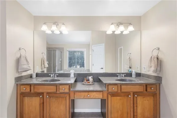 a bathroom with a toilet and a chair