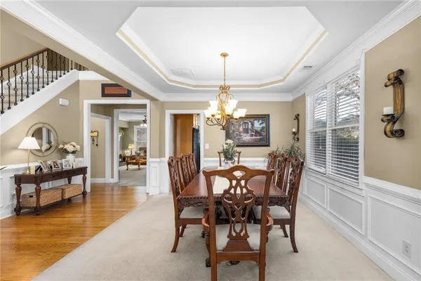 a dining room with furniture and a piano