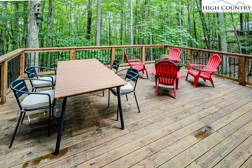 821 Pine Ridge Road Beech Mountain, NC 28604 - Photo 31 of 38 a view of deck with table and chairs and wooden floor