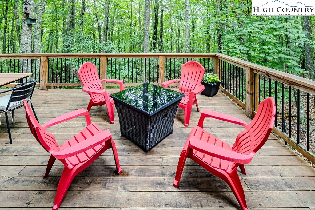 821 Pine Ridge Road Beech Mountain, NC 28604 - Photo 34 of 38 a balcony with a couch and wooden floor
