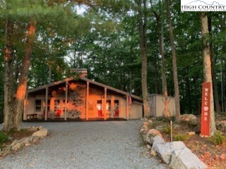 821 Pine Ridge Road Beech Mountain, NC 28604 - Photo 5 of 38 a view of a house with backyard and trees