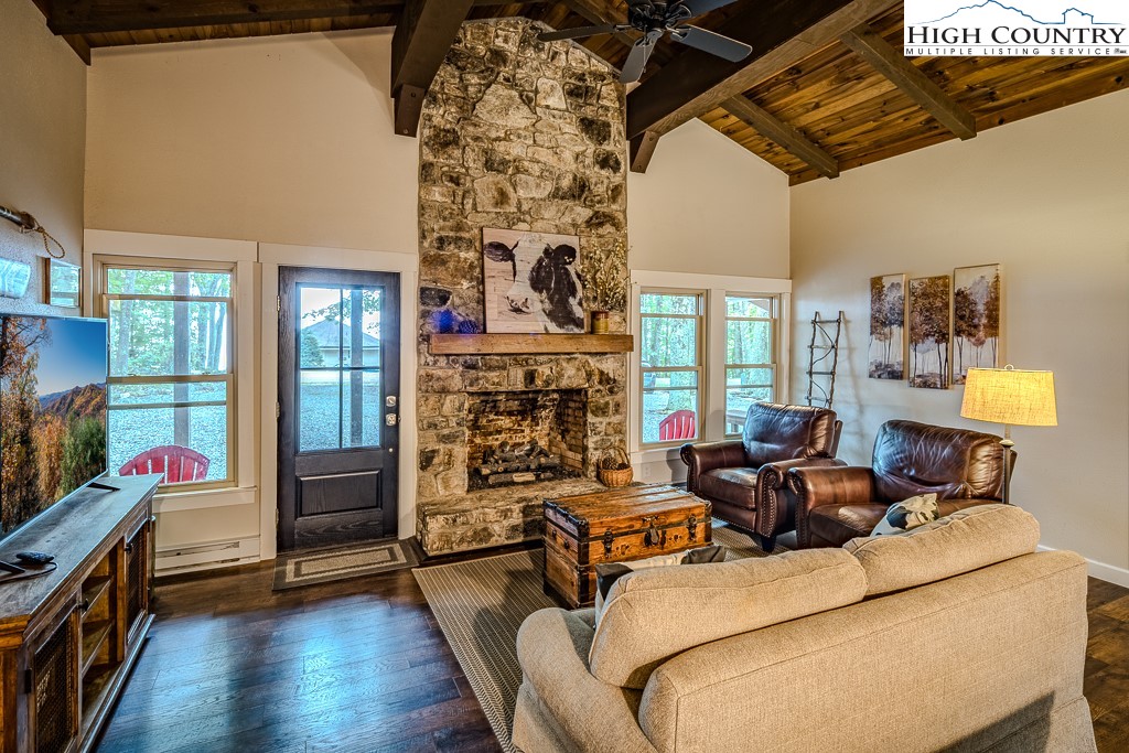 821 Pine Ridge Road Beech Mountain, NC 28604 - Photo 6 of 38 a living room with furniture a fireplace and a flat screen tv